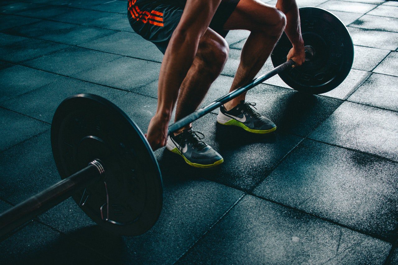 A man is lifting some weight with one hand