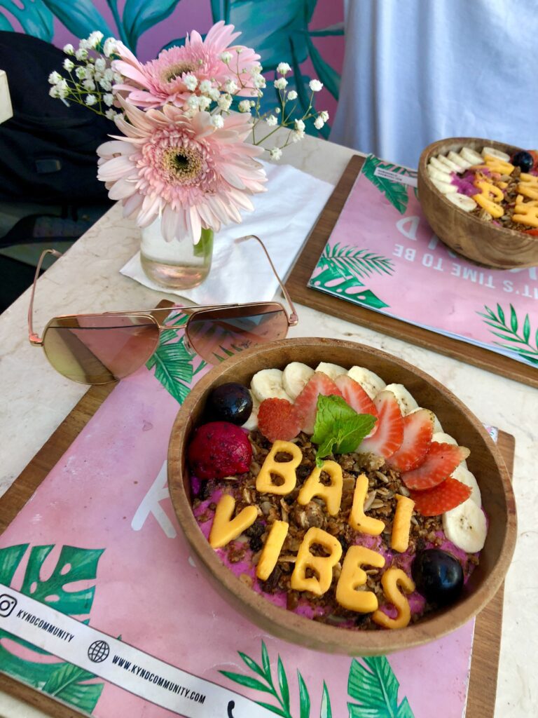 A bowl of fruit with the words bali vibes written in it.