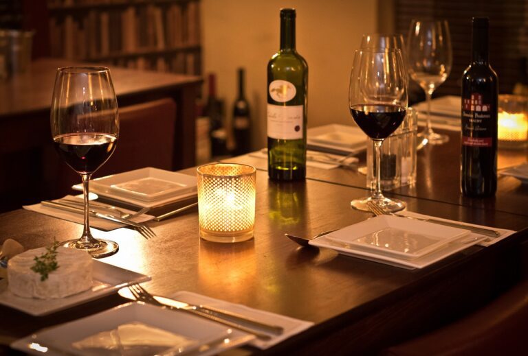 A table with wine glasses and candles on it