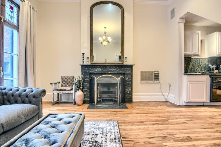 A living room with hard wood floors and fireplace.