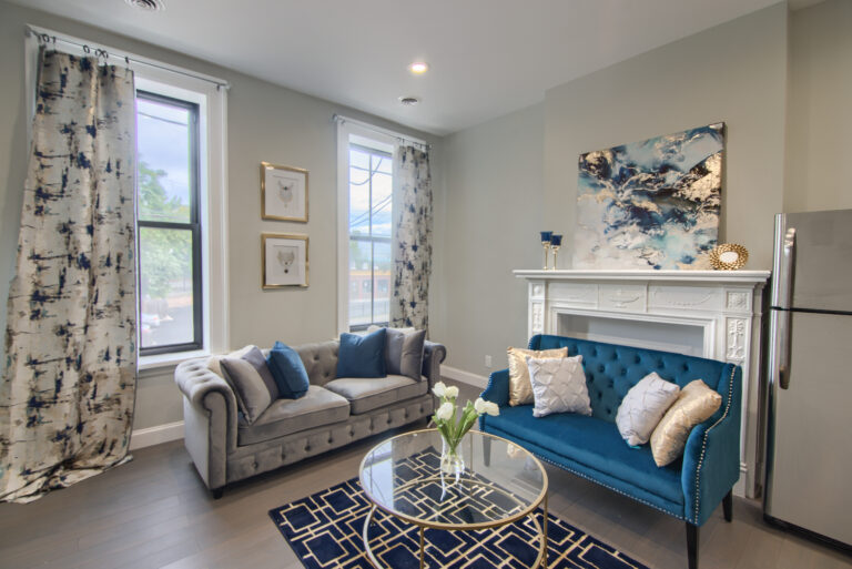 A living room with two couches and a fireplace.