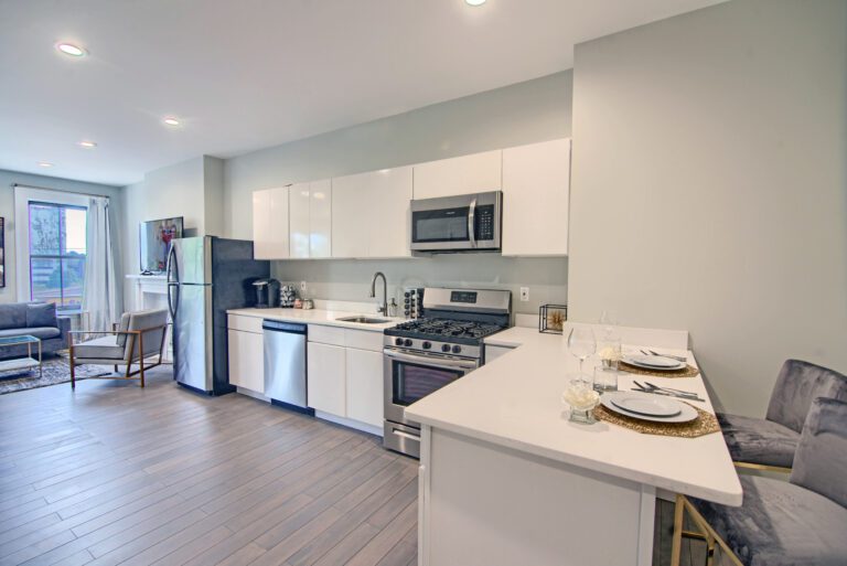 A kitchen with white cabinets and stainless steel appliances.