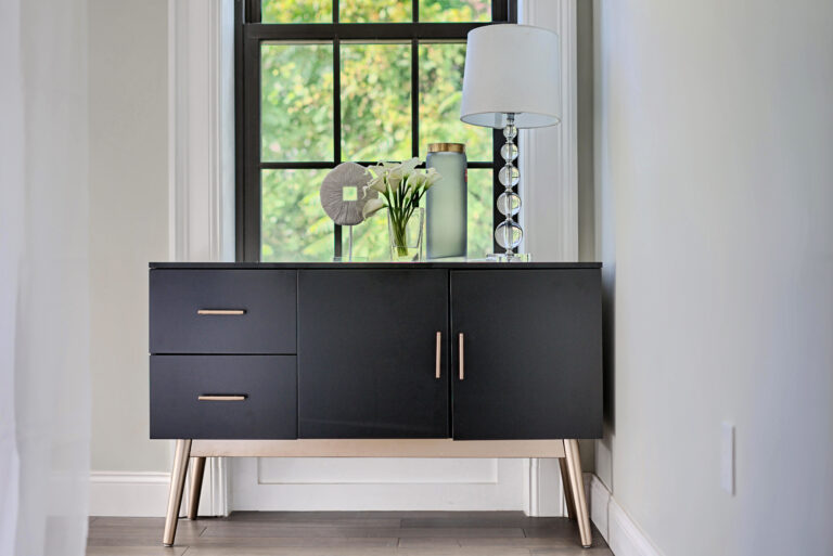 A black cabinet with two drawers and one door.