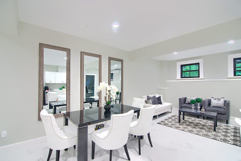 A living room with white walls and black table