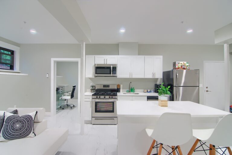 A kitchen with white cabinets and appliances in it