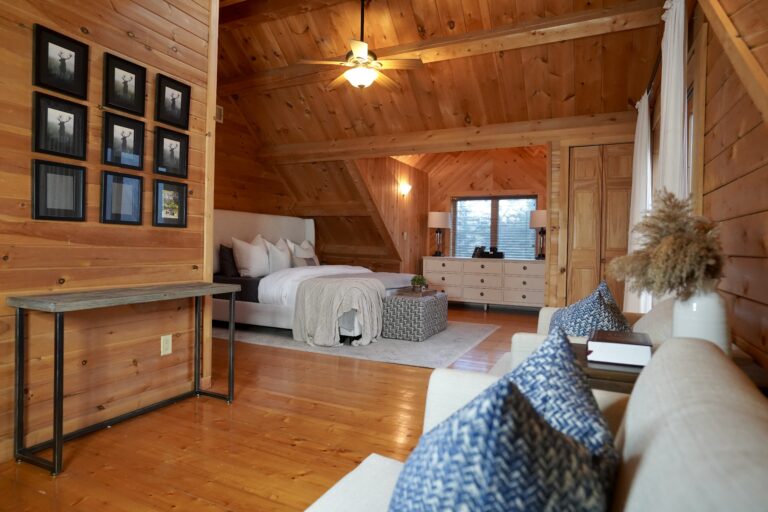 A bedroom with wood floors and wooden walls.